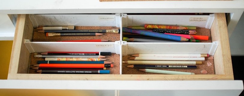 colored pencils in white wooden drawer