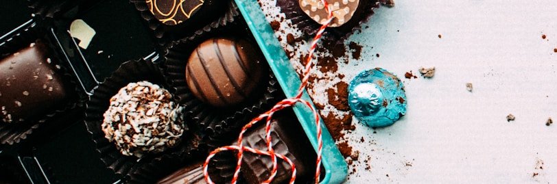 chocolates with box on white surface