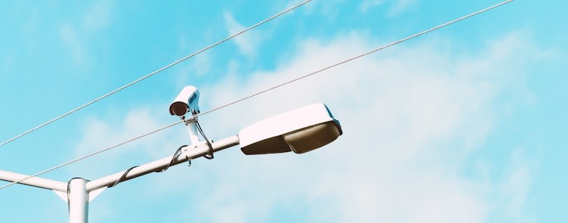 closeup photo of white lamp post and camera