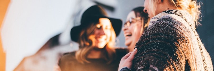 people laughing and talking outside during daytime