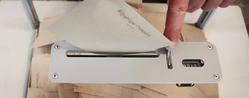 person holding white machine on top of white table