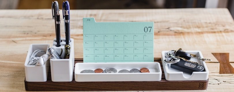 coin on tray beside pen organizer on table