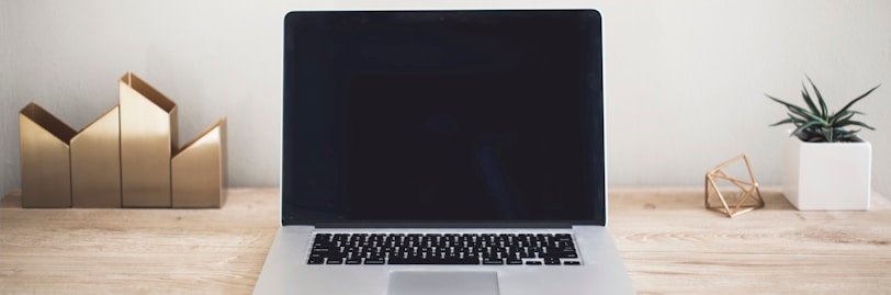 MacBook Pro on top of brown table