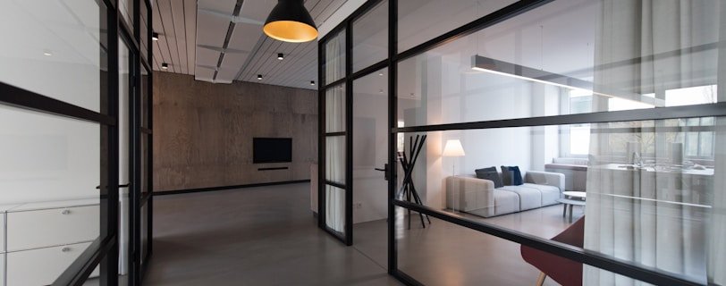 room with glass divider and white curtain