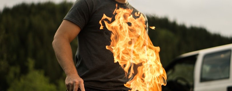 man grilling near white vehicle