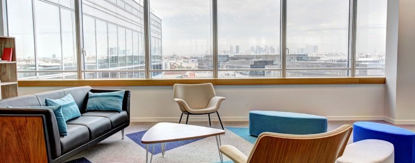 ottomans and chairs inside the room
