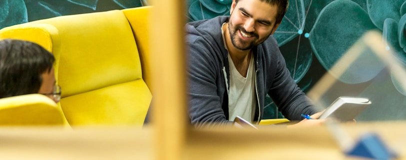 two men sitting on sofa