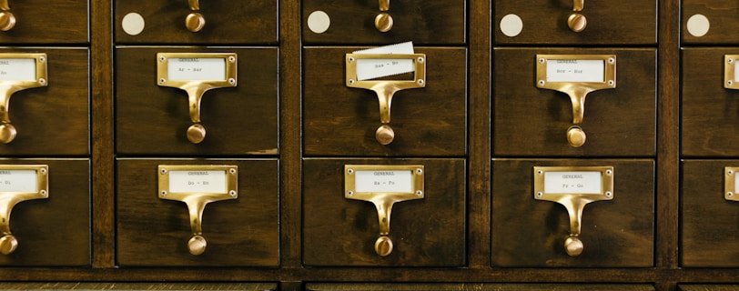 close-up photography of brown wooden card catalog