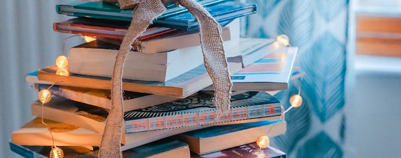 brown wooden framed candle holder on top of books