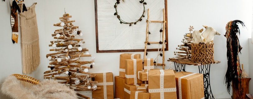 brown cardboard brown beside brown Christmas tree inside room during daytime
