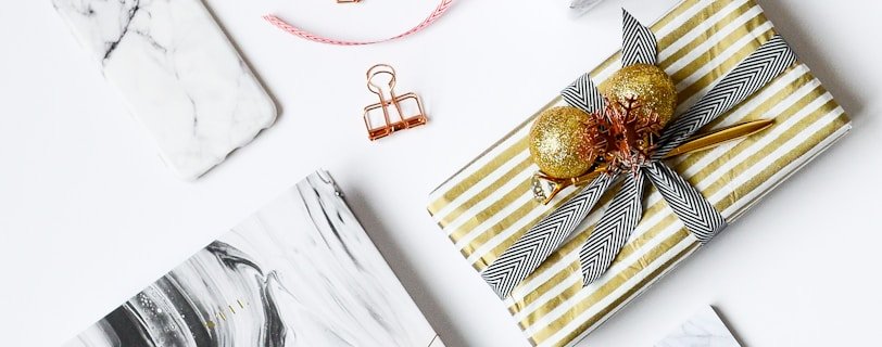 several assorted-color present boxes and notebook on table