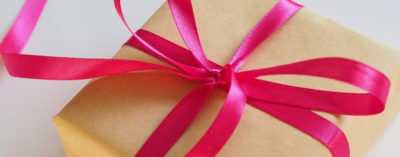brown gift box with pink ribbon