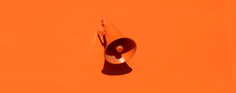 orange megaphone on orange wall