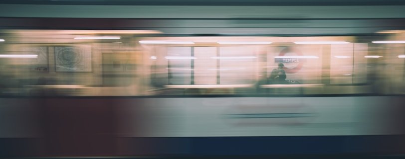 time lapse photo of speeding train