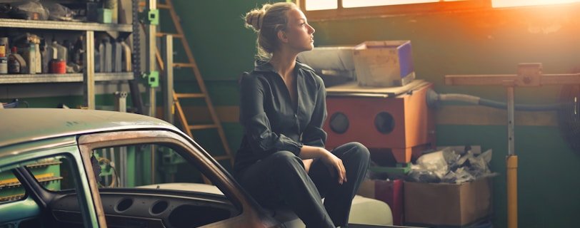 woman sitting on orange vehicle