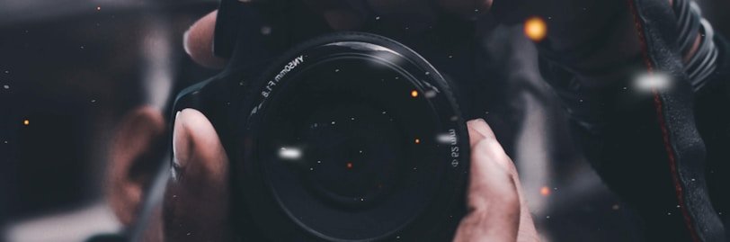 person holding black DSLR camera