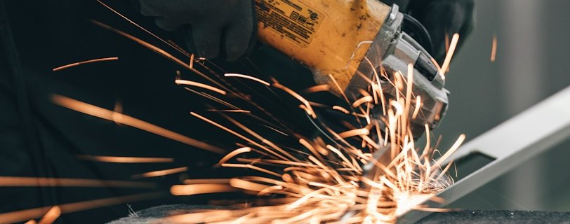 a man using a grinder on a piece of metal