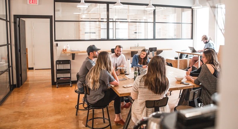 talking people sitting beside table