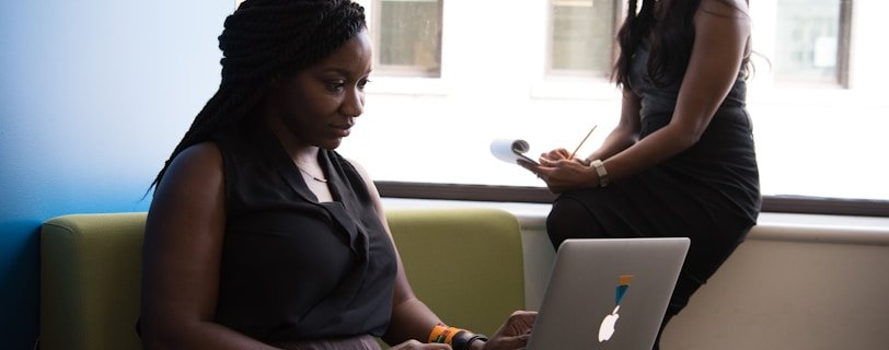 shallow focus photo of woman using MacBook