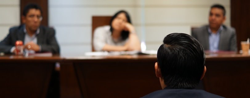 man in black shirt sitting beside woman in white shirt