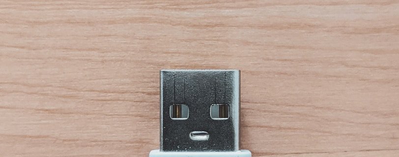 white usb flash drive on brown wooden table
