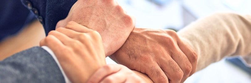 person in black long sleeve shirt holding persons hand