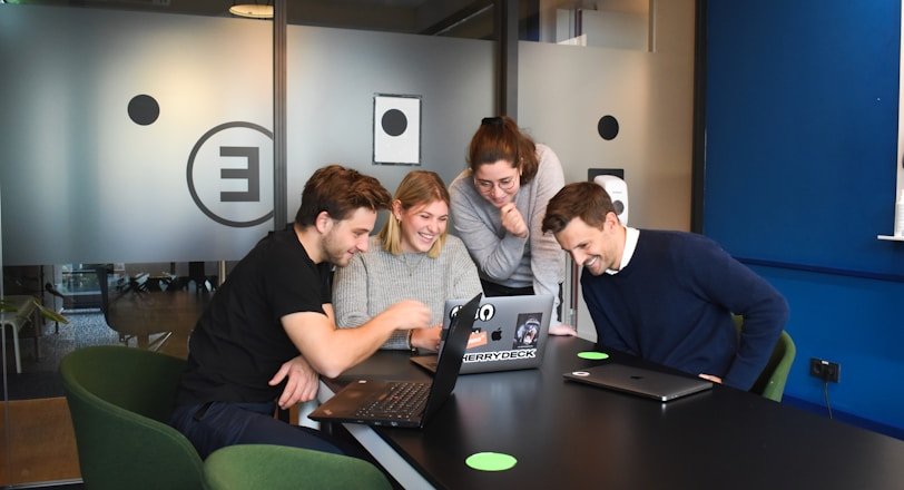 people sitting on chair in front of laptop computers