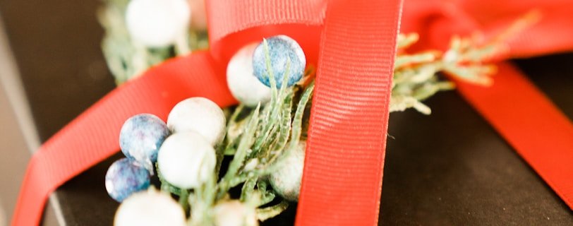 white and green flower bouquet on brown wooden table