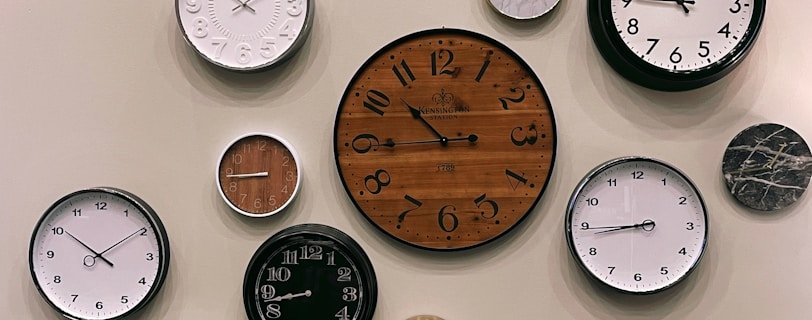 white and brown analog wall clock at 10 00