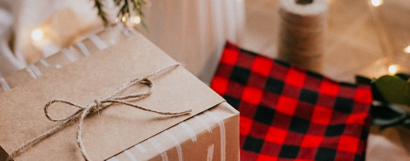 brown and white gift box on red and white checkered textile