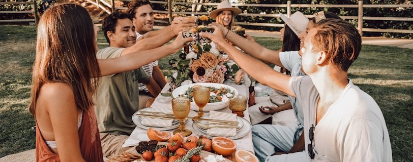 people sitting on chair eating food during daytime