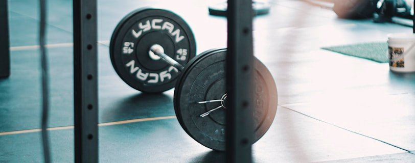 a gym with a barbell and weight plates