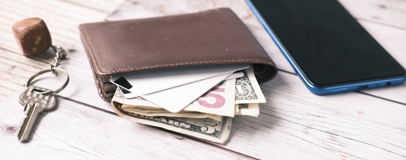 black leather bifold wallet on white table