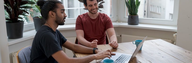 man in black crew neck t-shirt sitting beside woman in red crew neck t-shirt