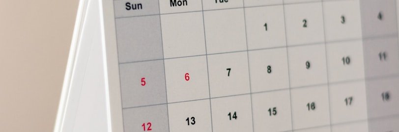 a desk calendar sitting on top of a wooden table