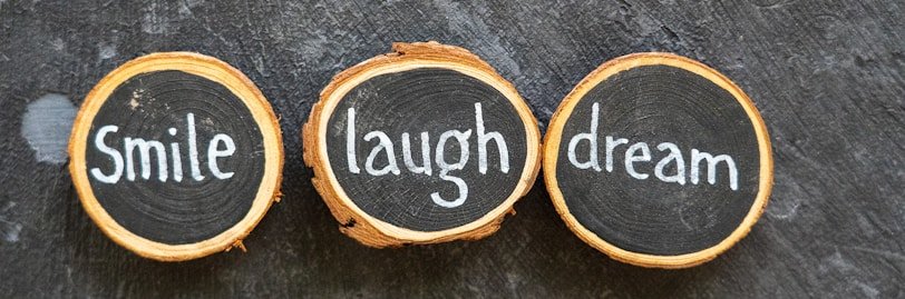 three slices of wood with words written on them