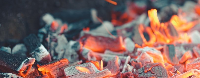 a close up of a grill with hot coal