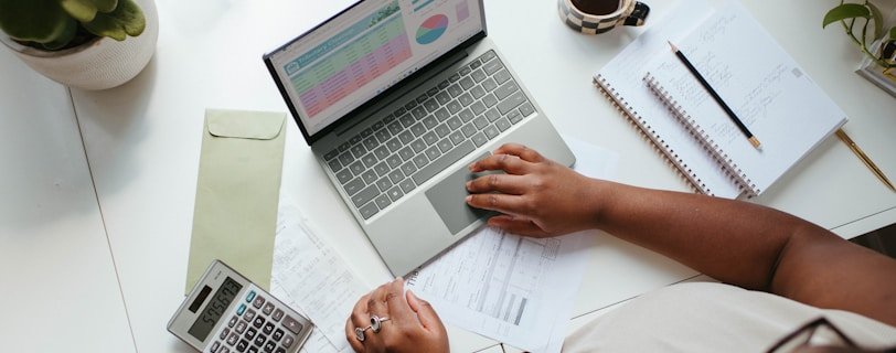 a person sitting at a table with a laptop
