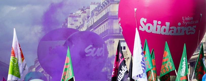 a crowd of people standing around a large balloon