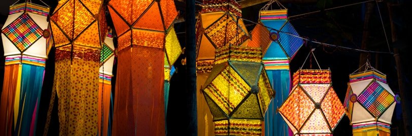 a group of colorful umbrellas hanging from a pole