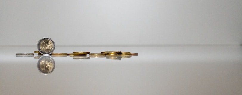 a coin sitting on top of a reflective surface